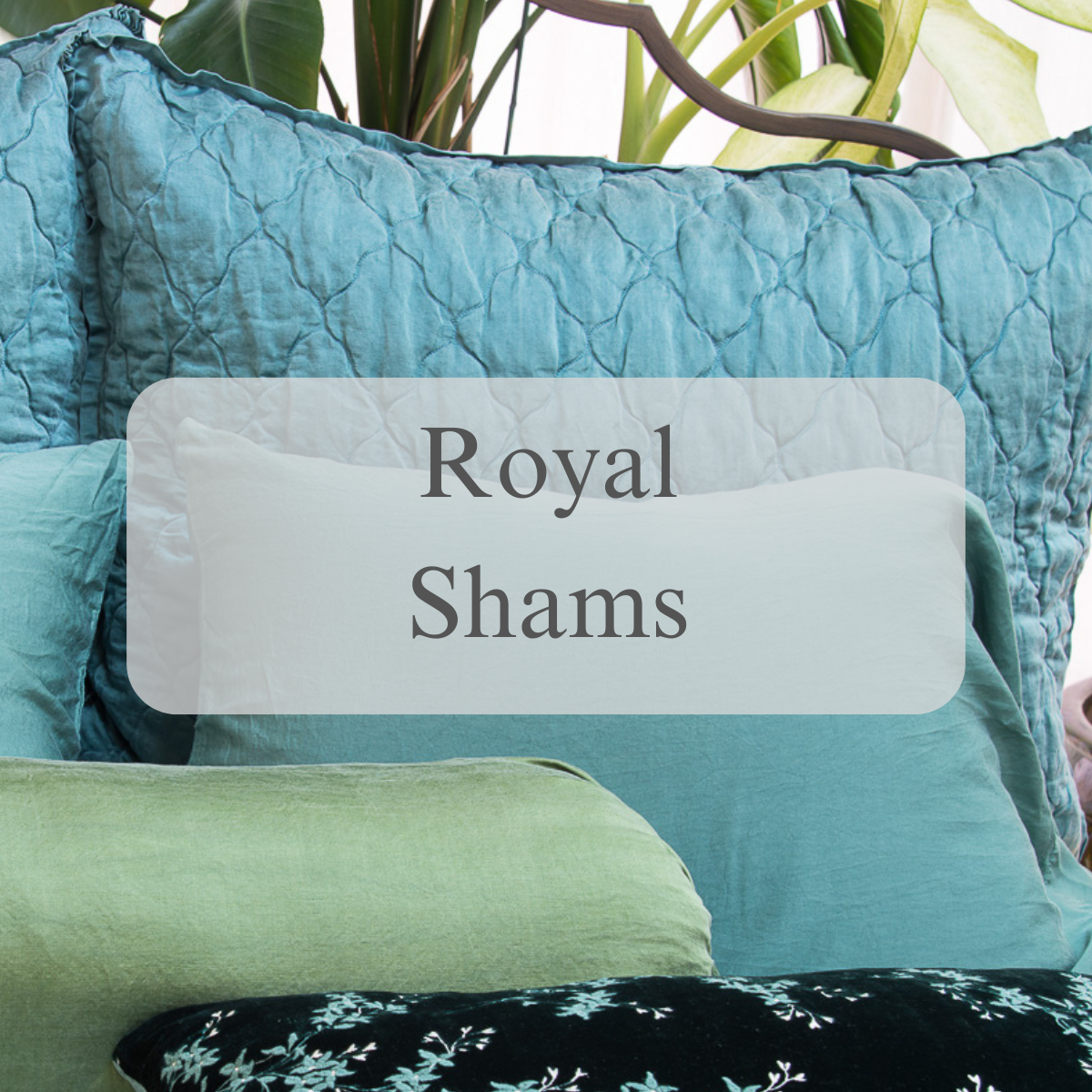 A shot of shams and pillows in blue and green tones with a text overlay that reads Royal Shams