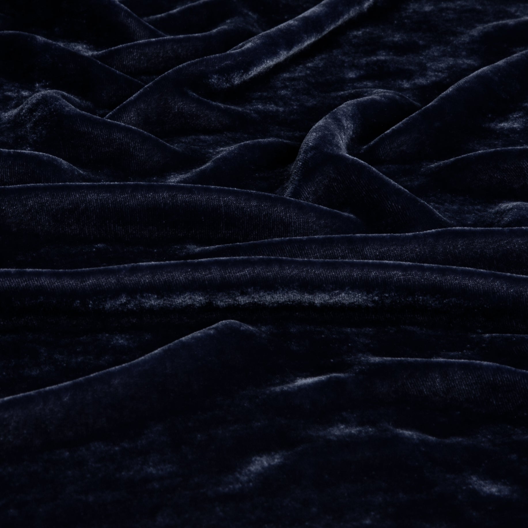 A close up of silk velvet gently rumpled in French Lavender, a purple tone