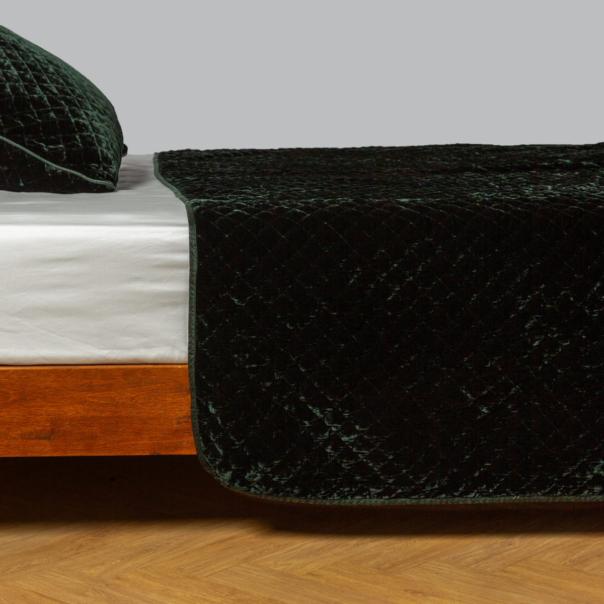  quilted silk velvet coverlet and matching sham on a winter white fitted sheet - side view. 