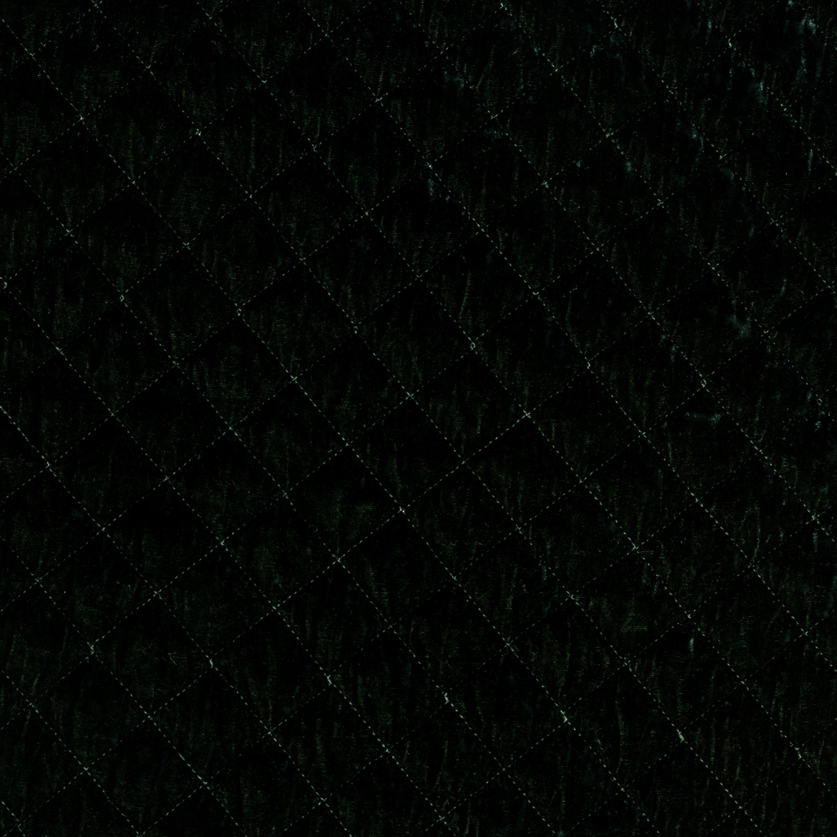 Juniper: A close up of quilted silk velvet fabric in Juniper, a deep green tone.
