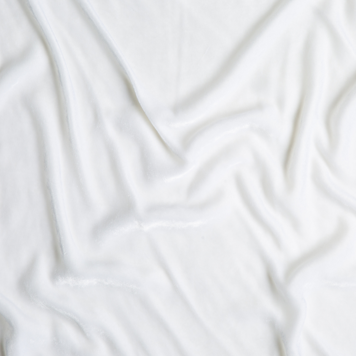 White: A close up of silk velvet fabric in classic white.