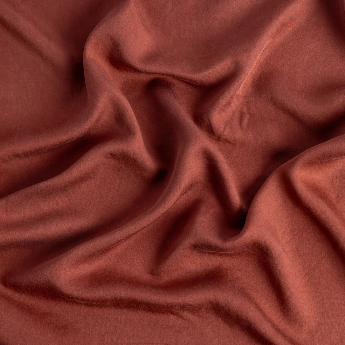 Autumn: A close up of Tencel™ fabric in autumn, a richly saturated persimmon color.
