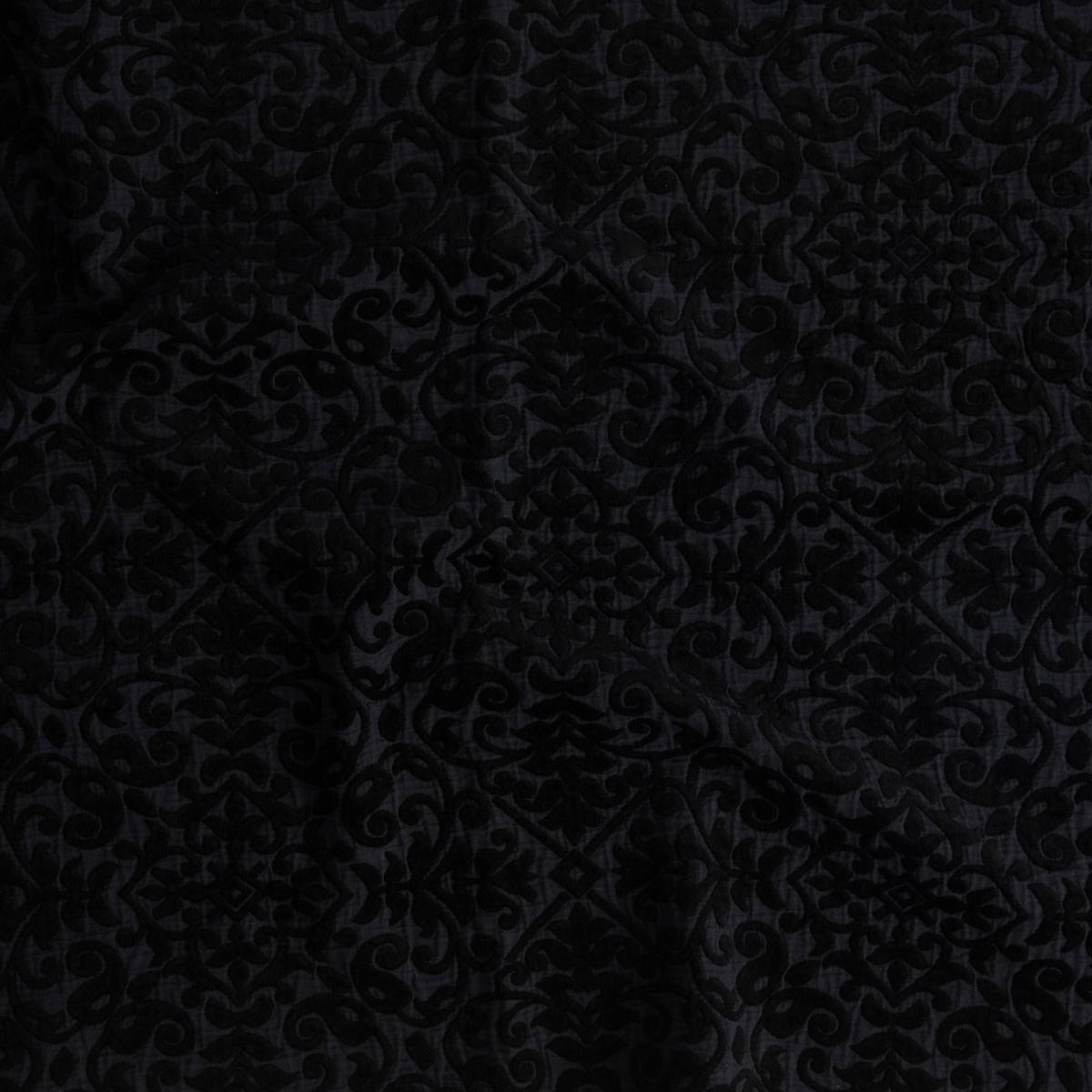 Corvino: A close up of cotton chenille fabric in Corvino, a black tone.