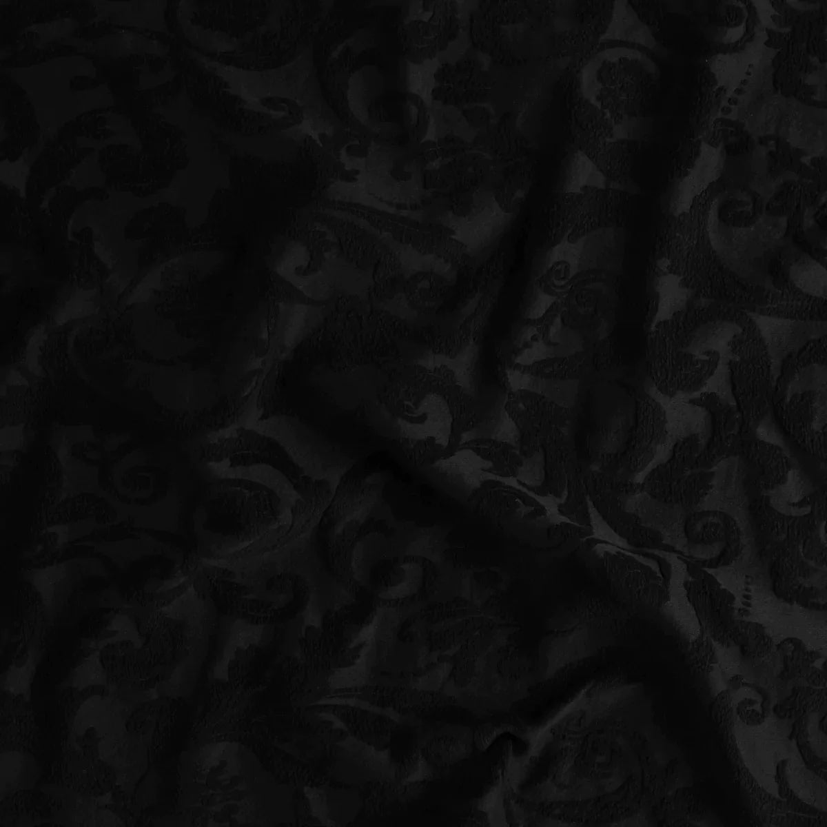 Corvino: A close up of Adele fabric in corvino, a black tone. The fabric is rumpled to show the cotton damask texture.
