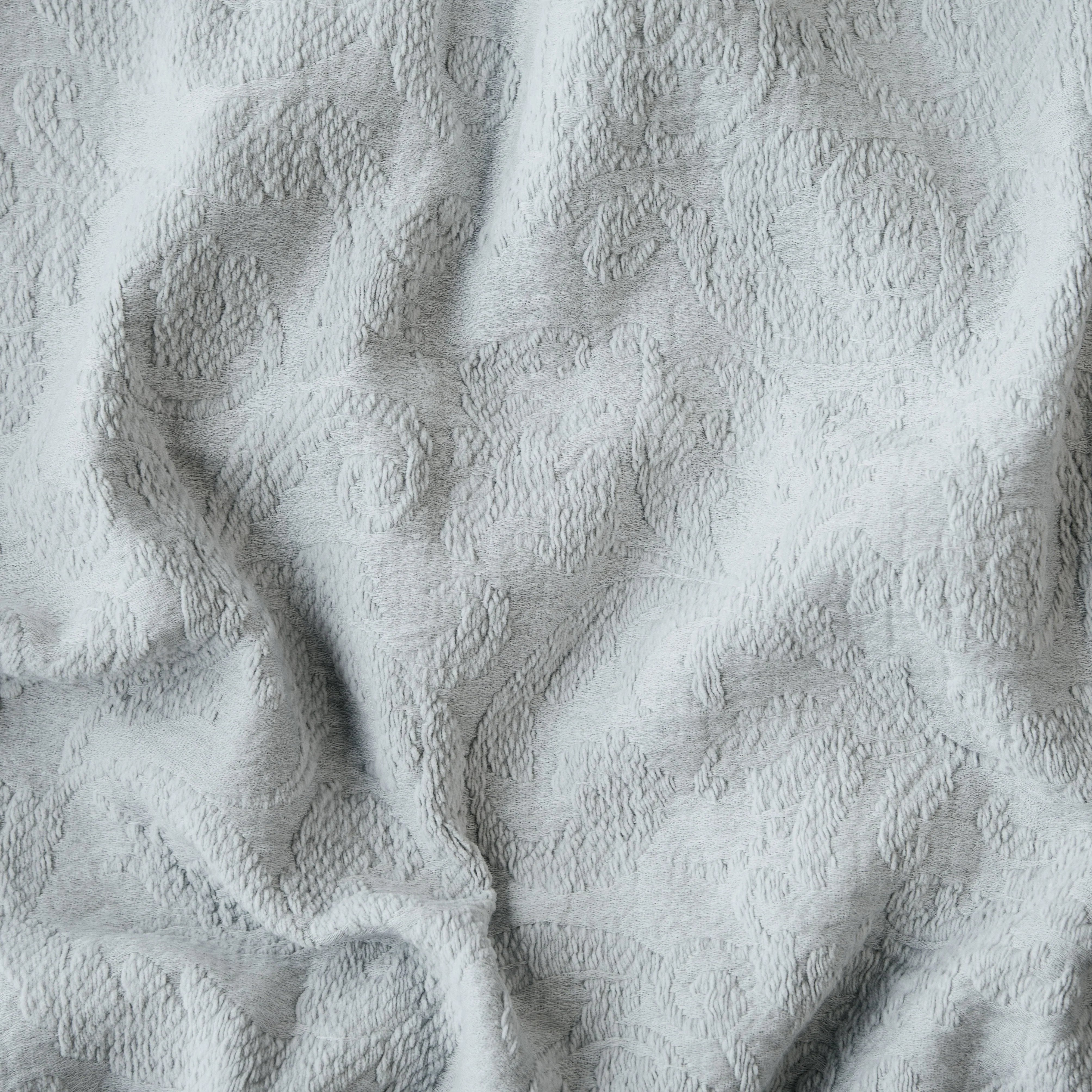 Cloud: A close up of Adele fabric in cloud, a soft, subtle sky blue-grey. The fabric is rumpled to show the cotton damask texture.