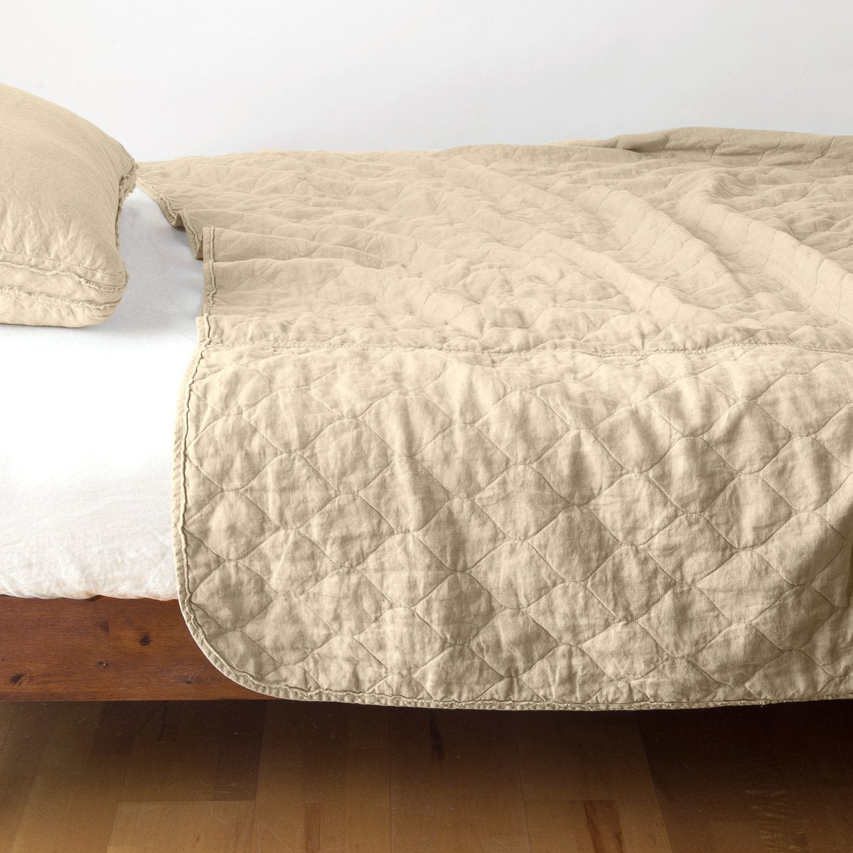 Honeycomb: quilted midweight linen coverlet on a bed - side view.