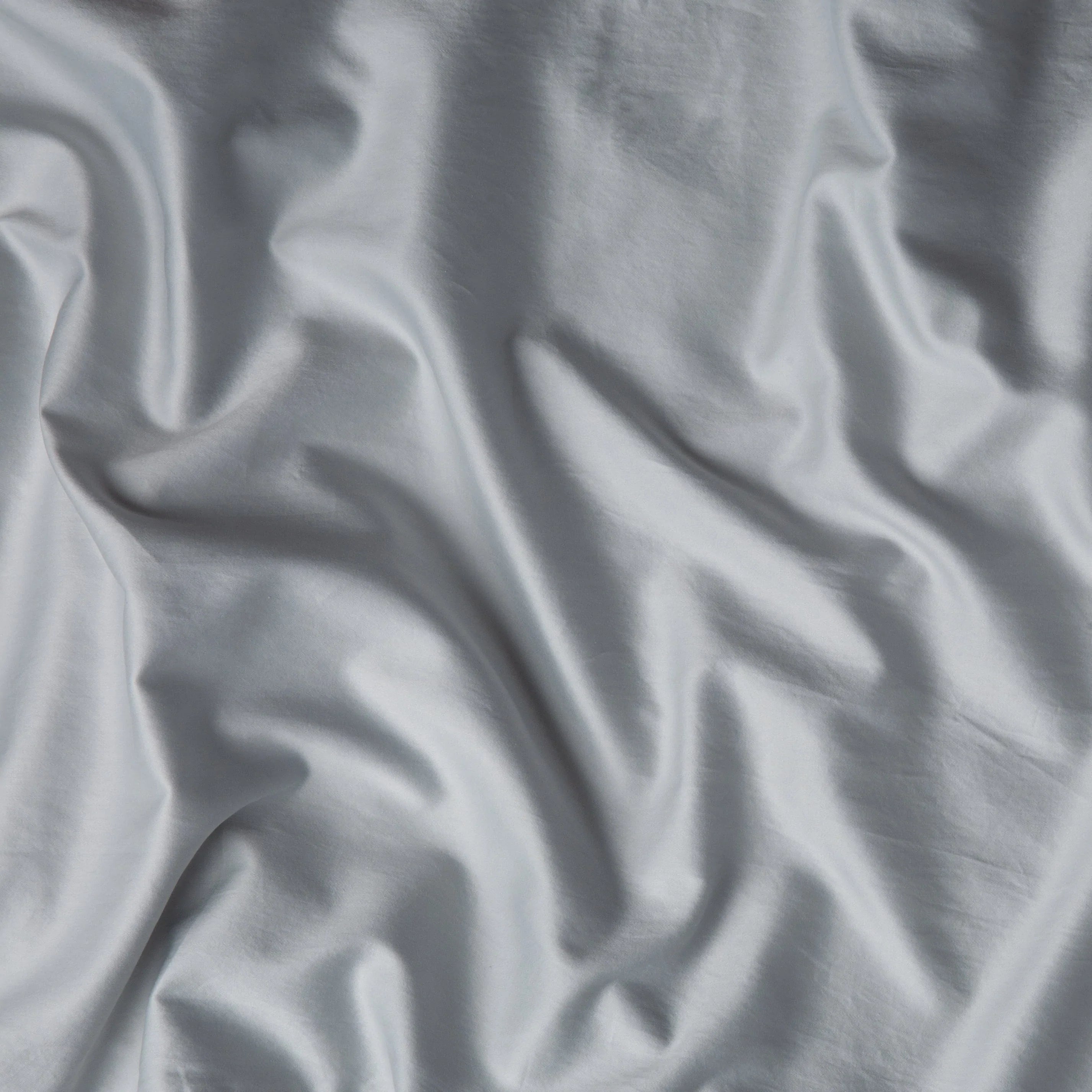 Cloud: A close up of cotton sateen fabric in cloud, a soft, subtle sky blue-grey. 