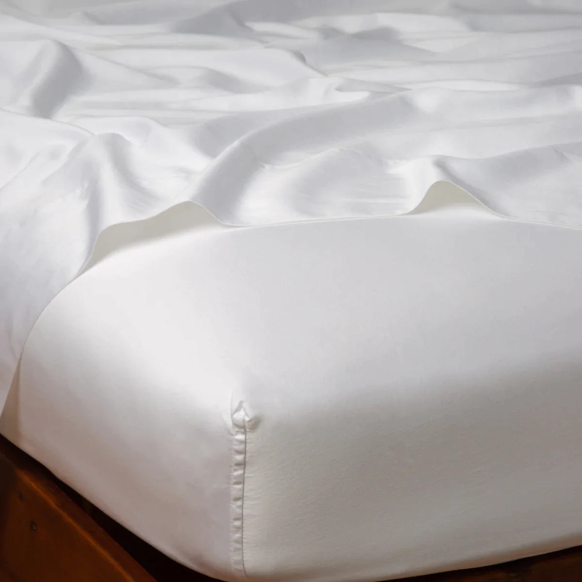 White: Cotton sateen fitted sheet shown from the top corner, highlighting the shine of the fabric.
