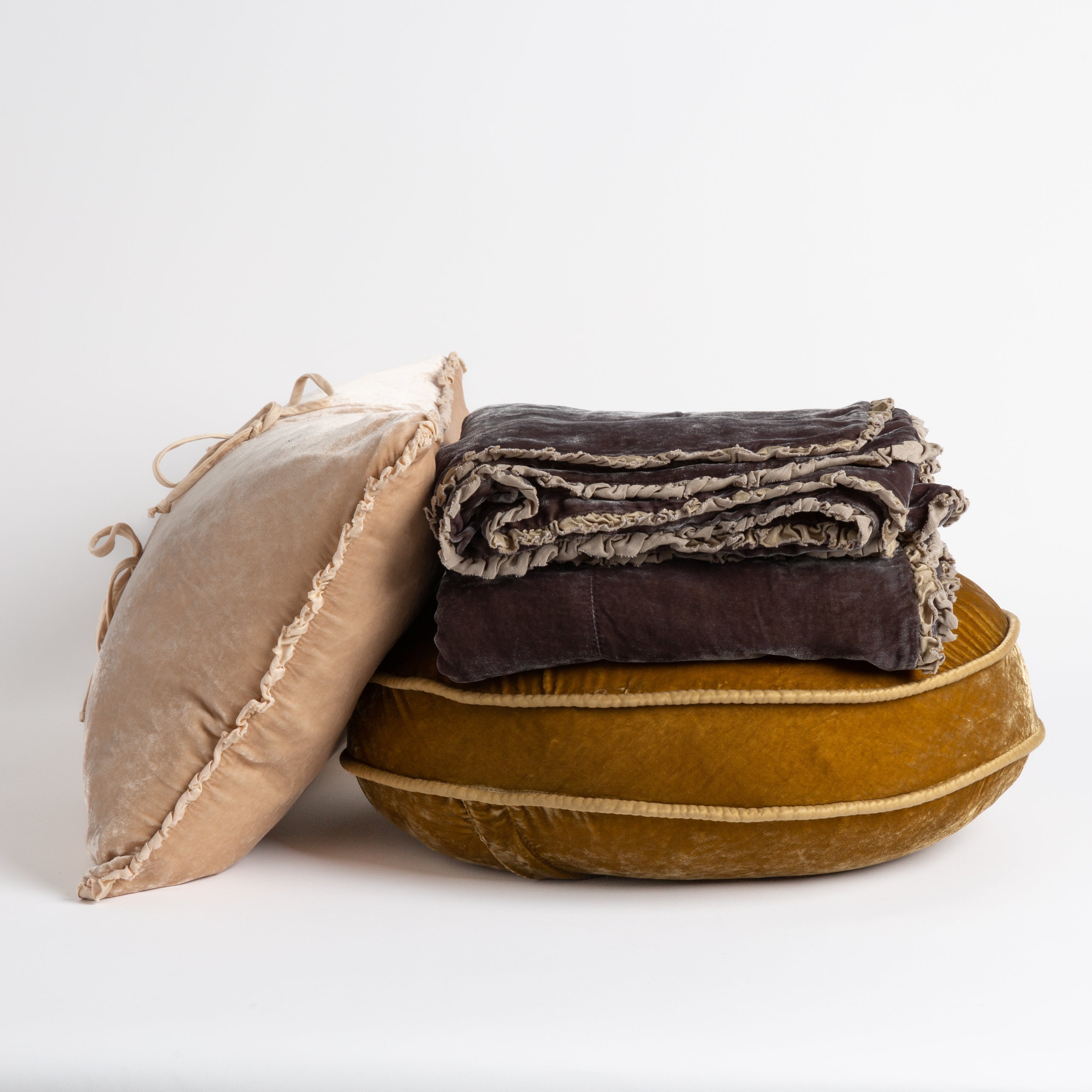 [allvariants]: silk velvet throw pillows and throw blanket on a white background, trim details are visible. 