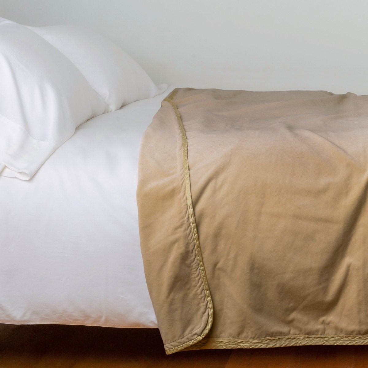 Honeycomb: Cotton velvet blanket, draped on a white bed with corner folded back - side view.