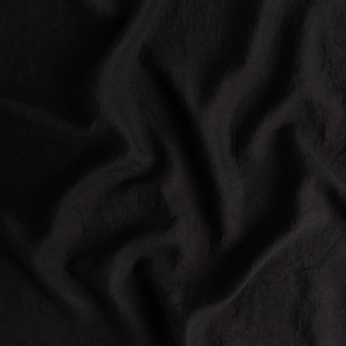 Corvino: close up of linen fabric in corvino, a black tone. 
