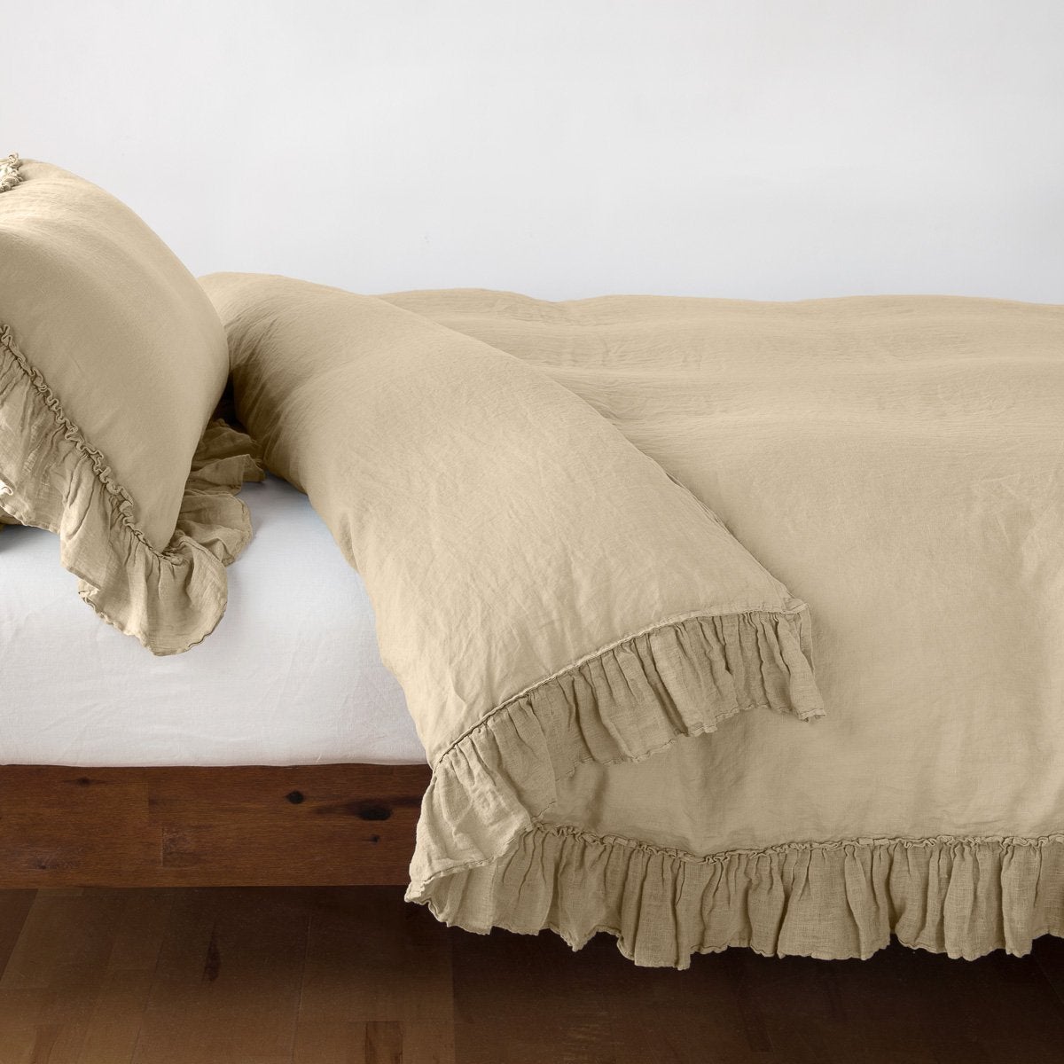 Honeycomb: duvet cover folded back over a white fitted sheet, shown with matching sham against a plain background - side view.