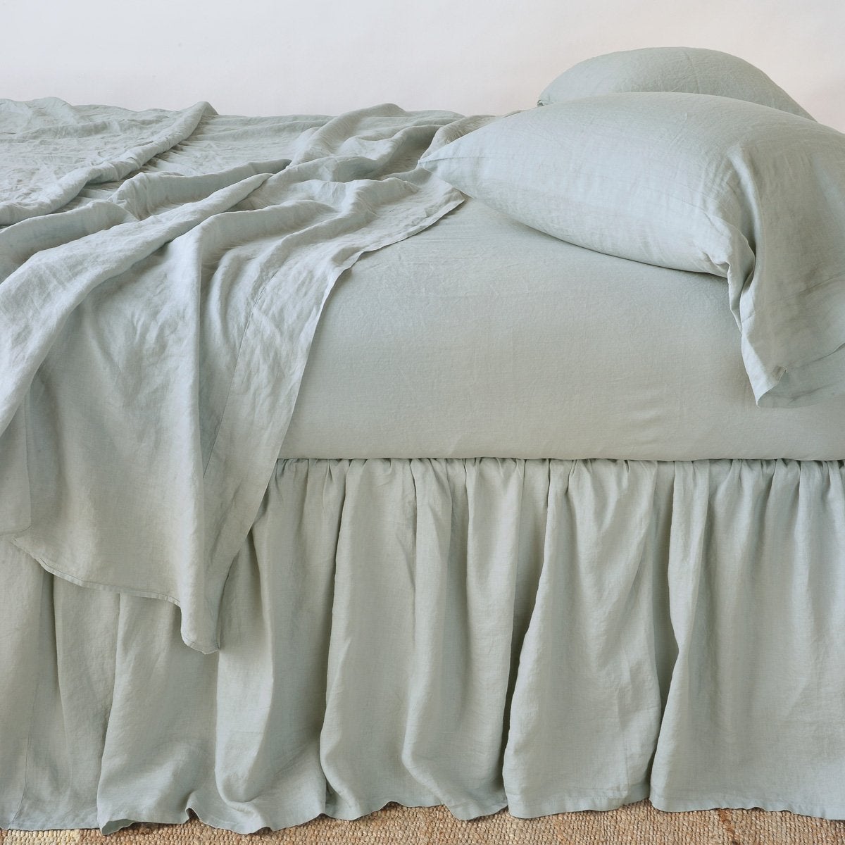 Eucalyptus: bed skirt with matching rumpled sheets and sleeping pillows - side view.