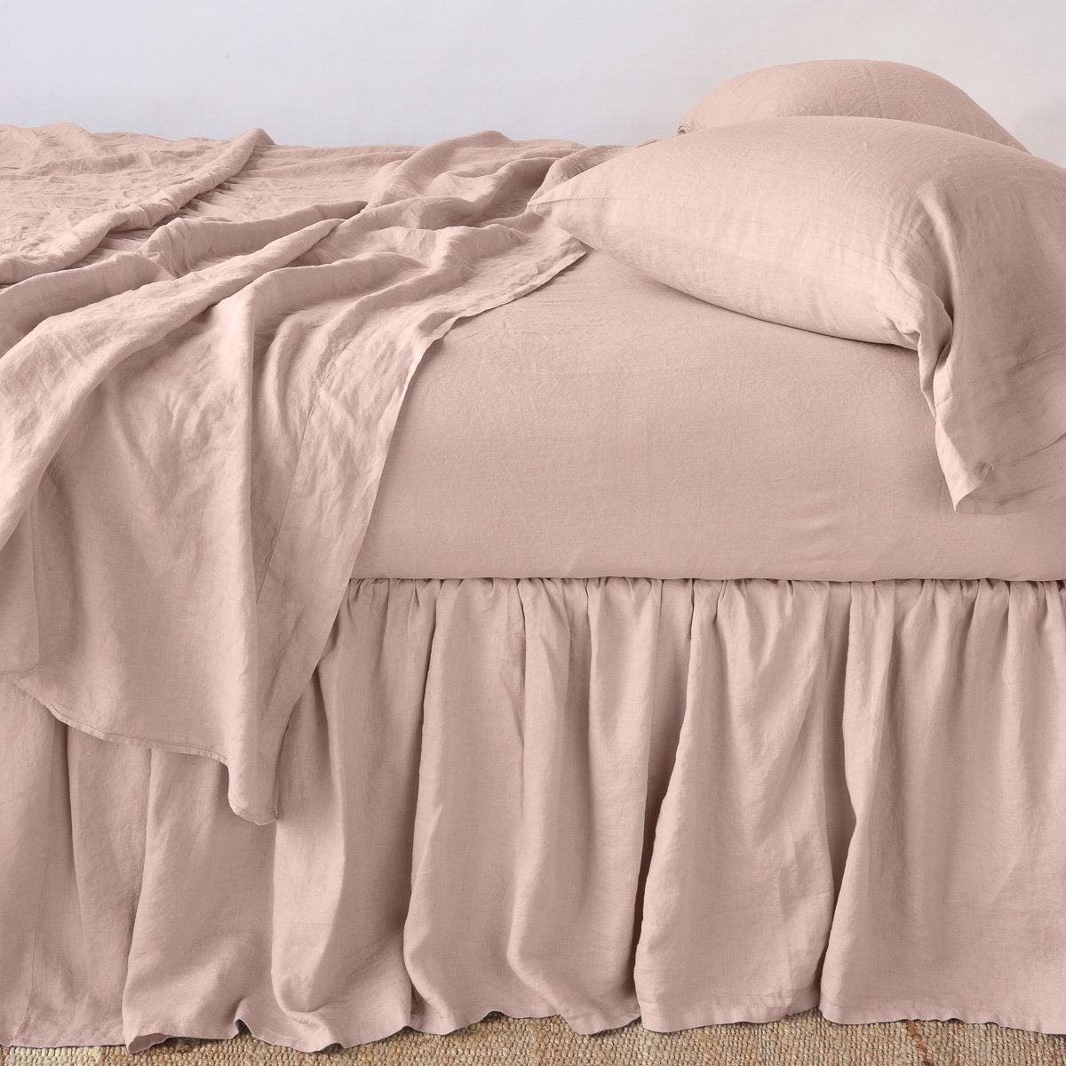 Rouge: bed skirt with matching rumpled sheets and sleeping pillows - side view.