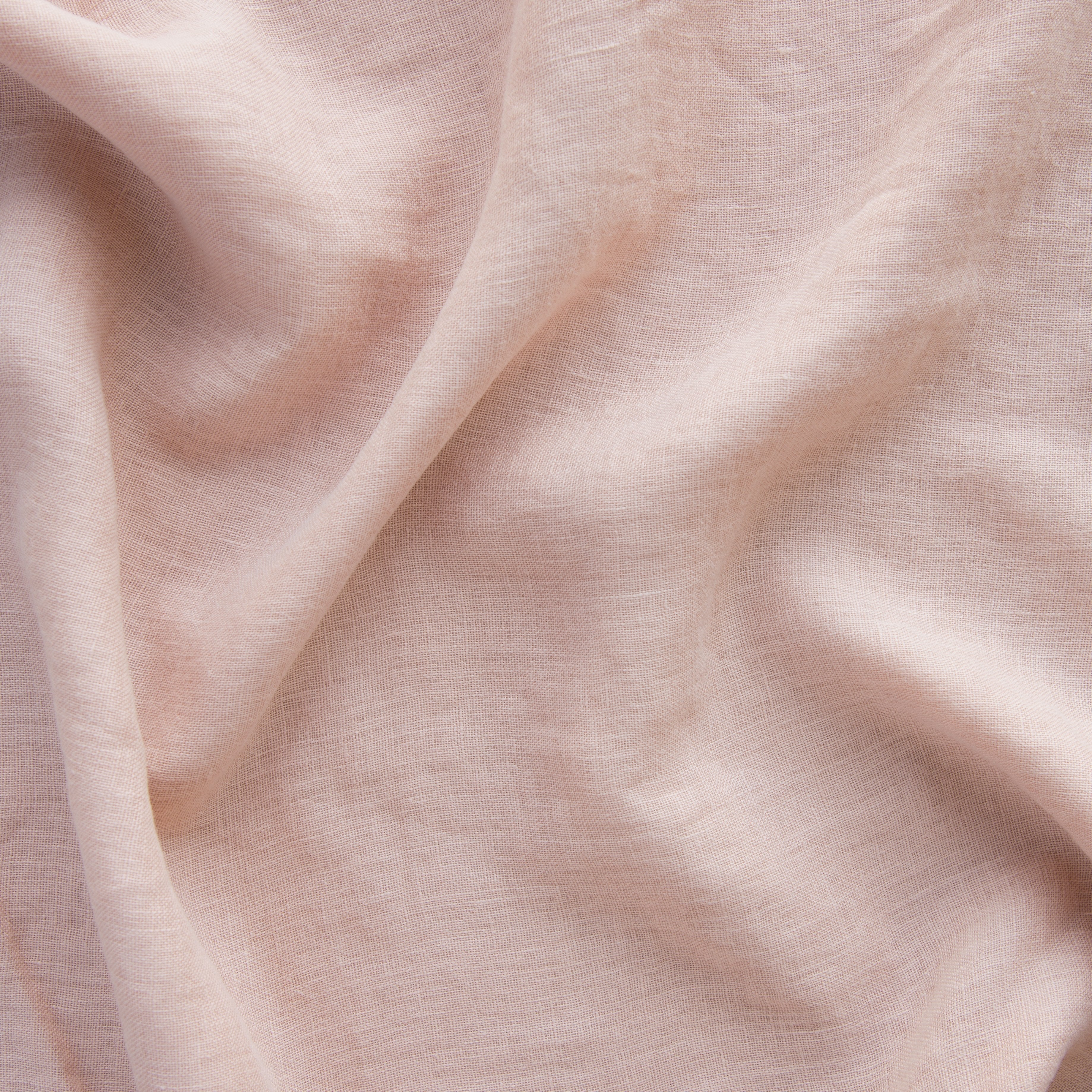 Rouge: A close up of linen whisper, our lightweight linen gauze, in rouge, a mid-tone blush pink.