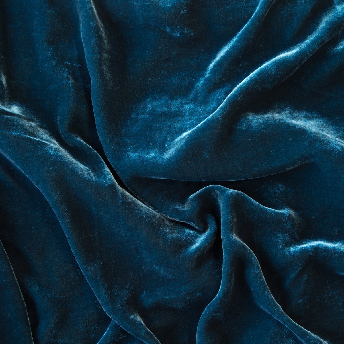 Cenote: A close up of silk velvet in cenote, a vibrant, ocean-inspired blue-green. 