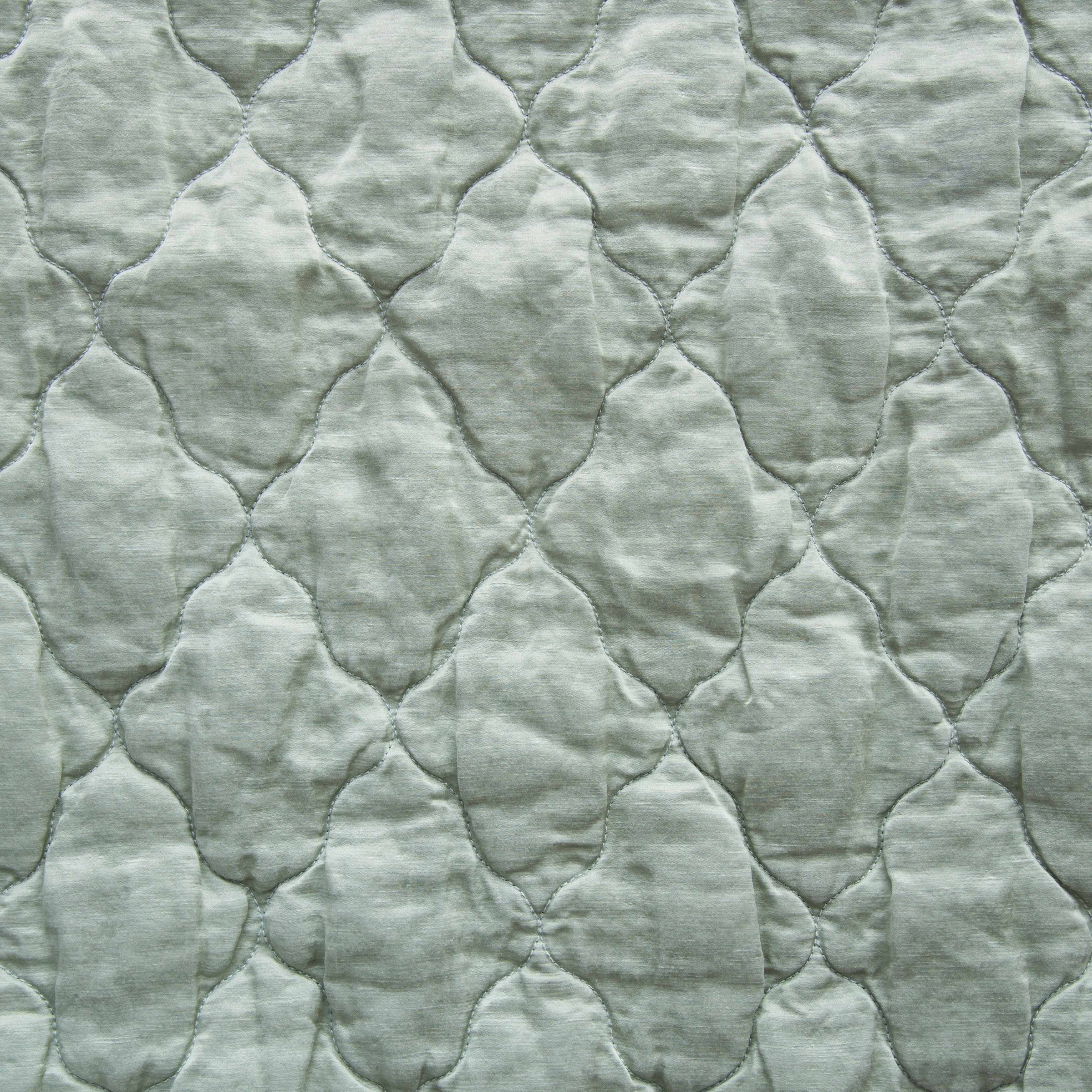 Eucalyptus: Close-up of Luna silk charmeuse quilting in cloud, a soft, subtle sky blue-grey. 