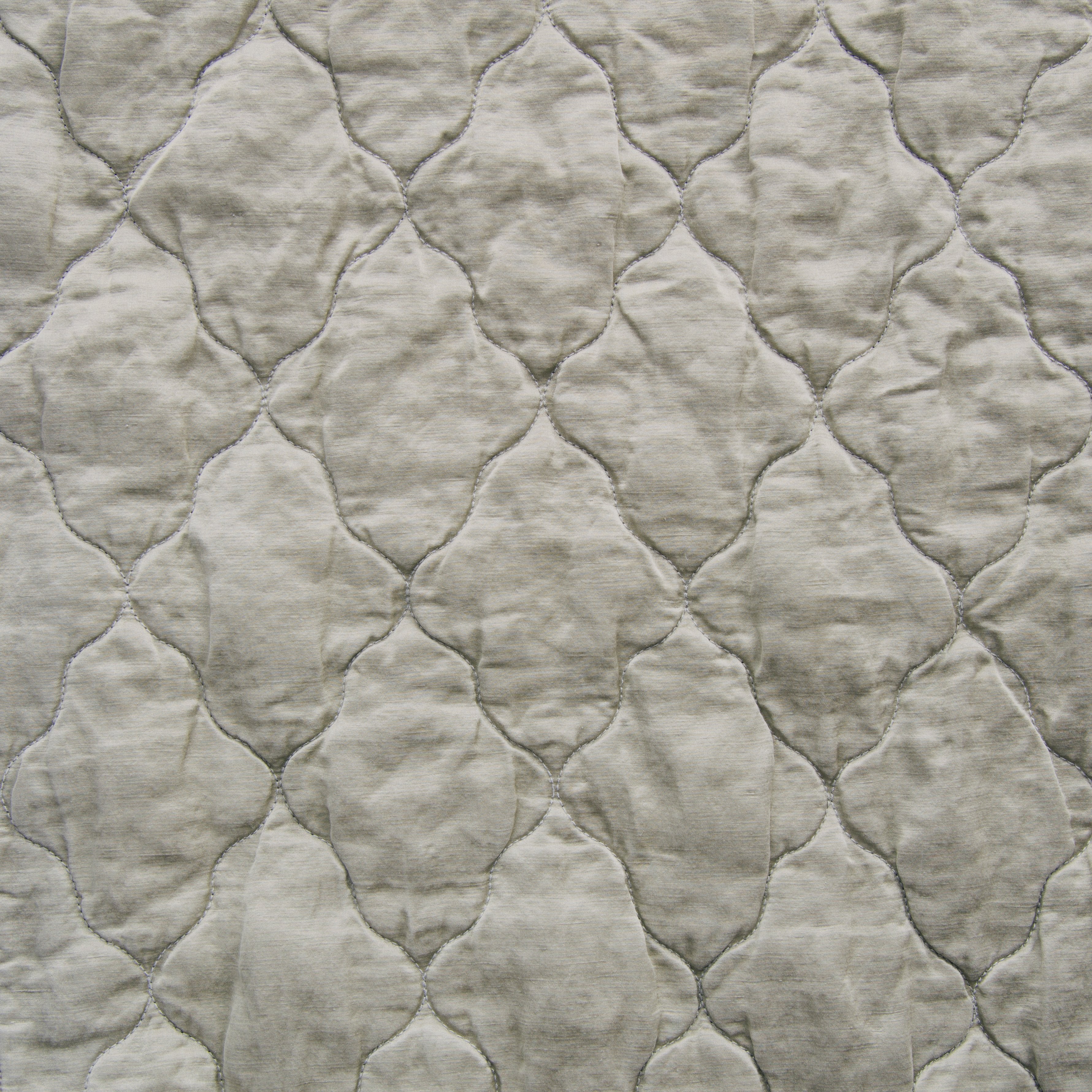 Fog: Close-up of Luna silk charmeuse quilting in fog, a neutral-warm, soft mid-tone grey. 