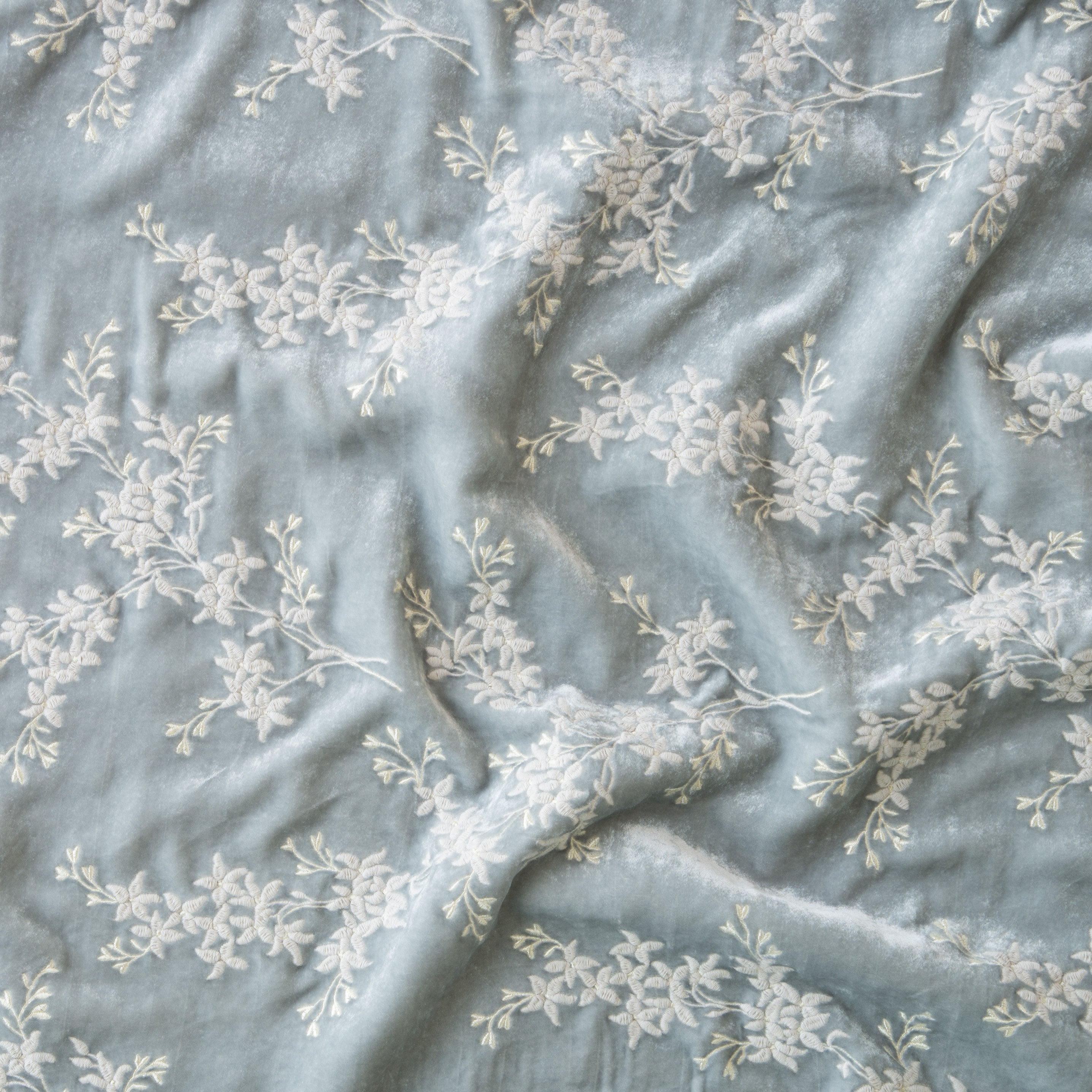 Sterling: A close up of Lynette embroidered silk velvet, in sterling, a silvery neutral light grey. 