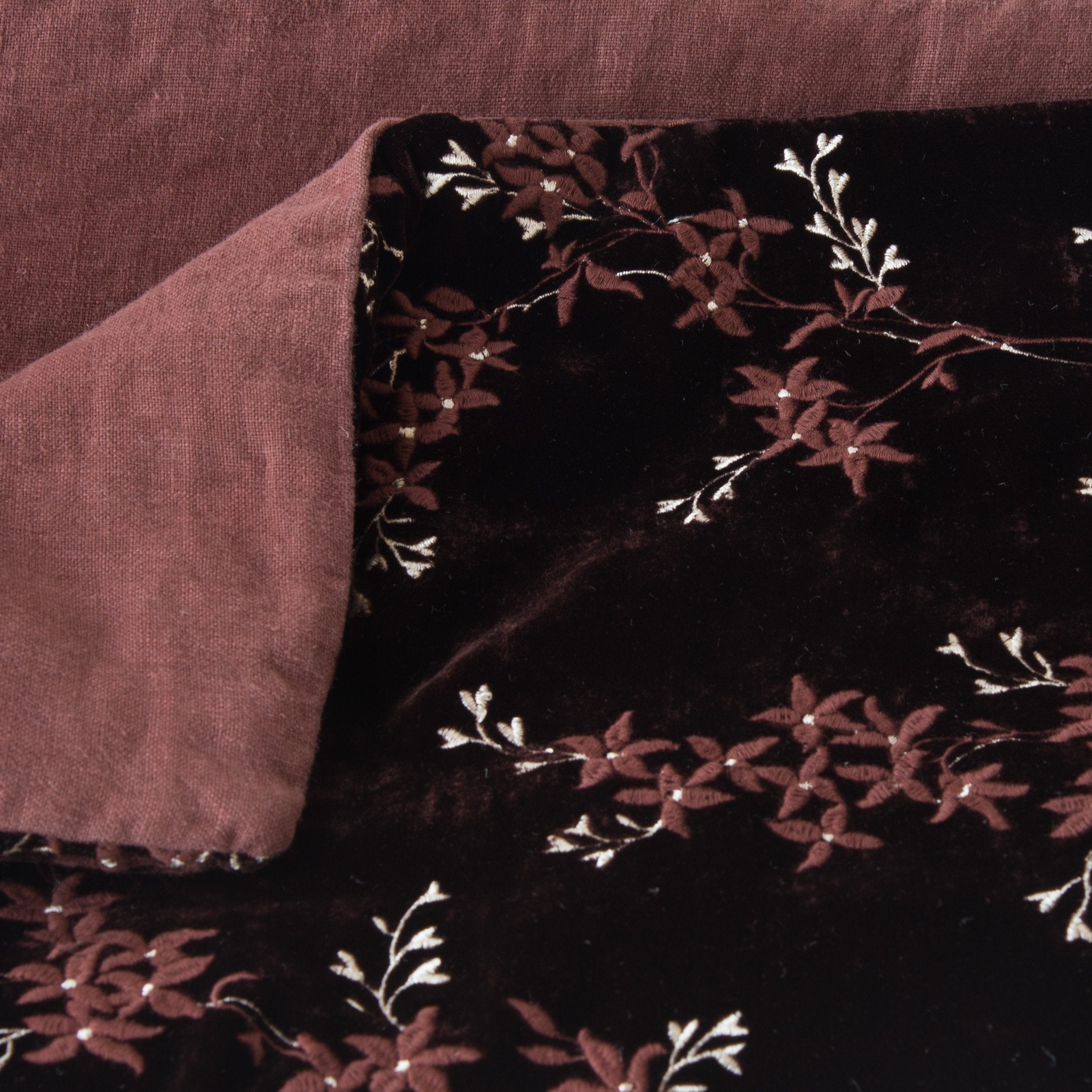 Mahogany: Close up of blanket, with a corner turned back to showcase the linen back - overhead view.