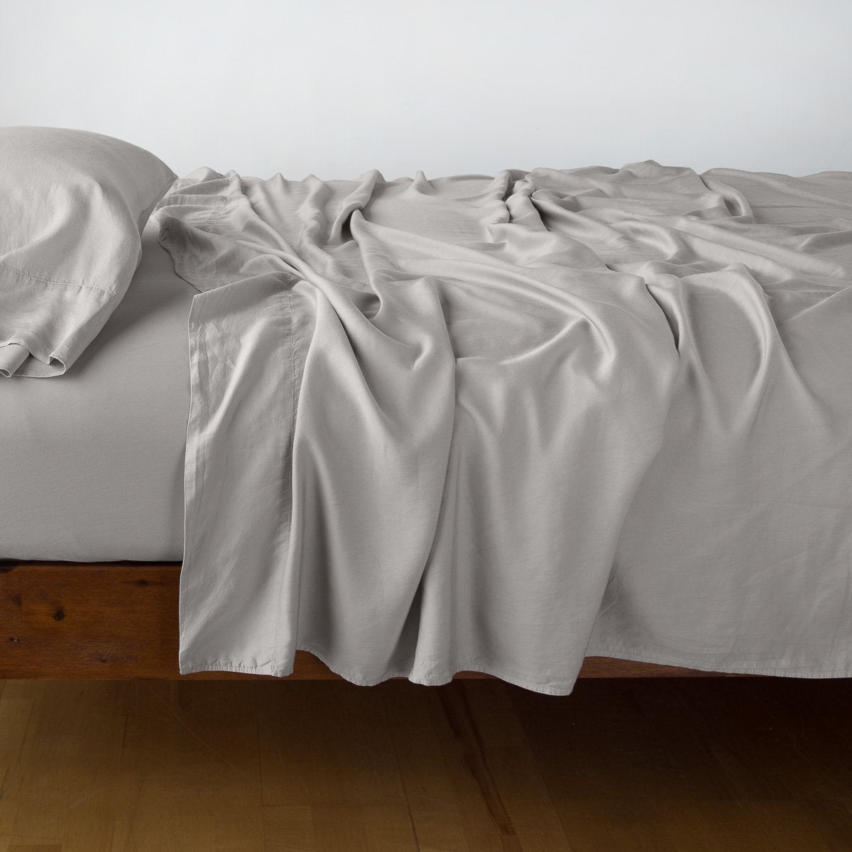 Fog: Rumpled flat sheet with matching fitted sheet and sleeping pillow - side view.