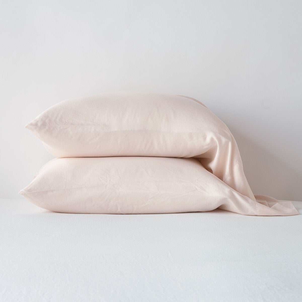 Pearl: sleeping pillows stacked neatly against a white backdrop - side view.