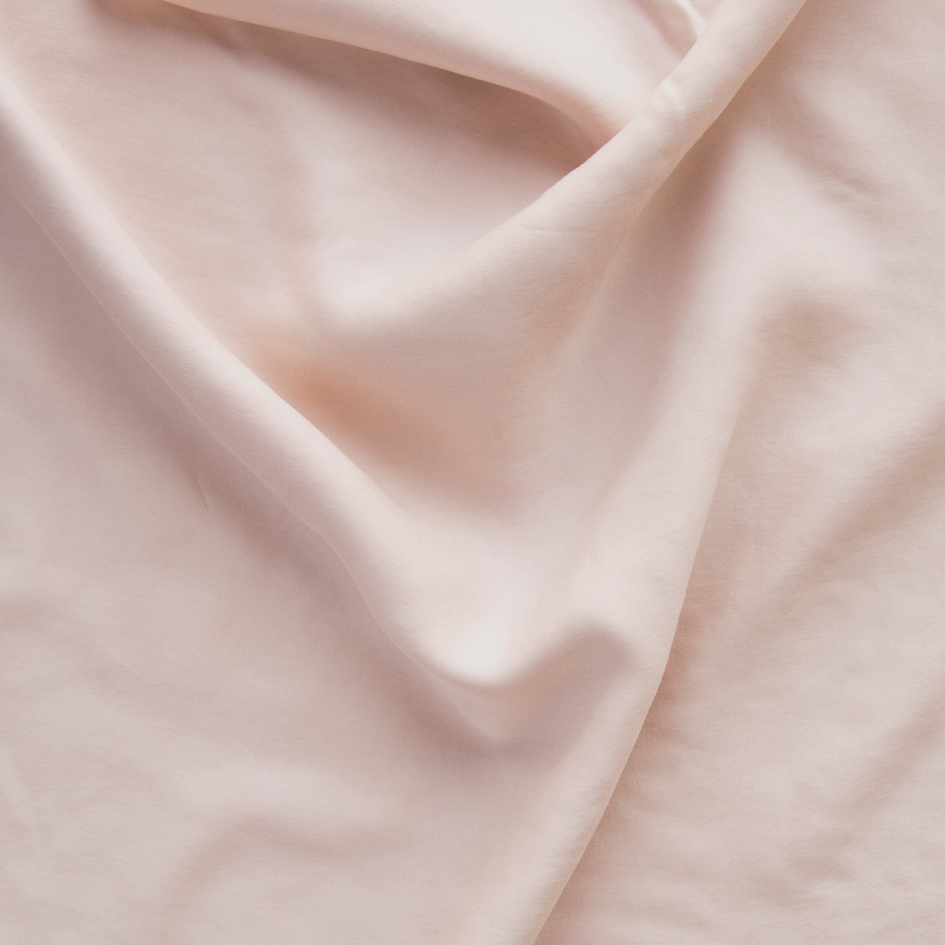 Rouge: A close up of Tencel™ fabric in rouge, a mid-tone blush pink.
