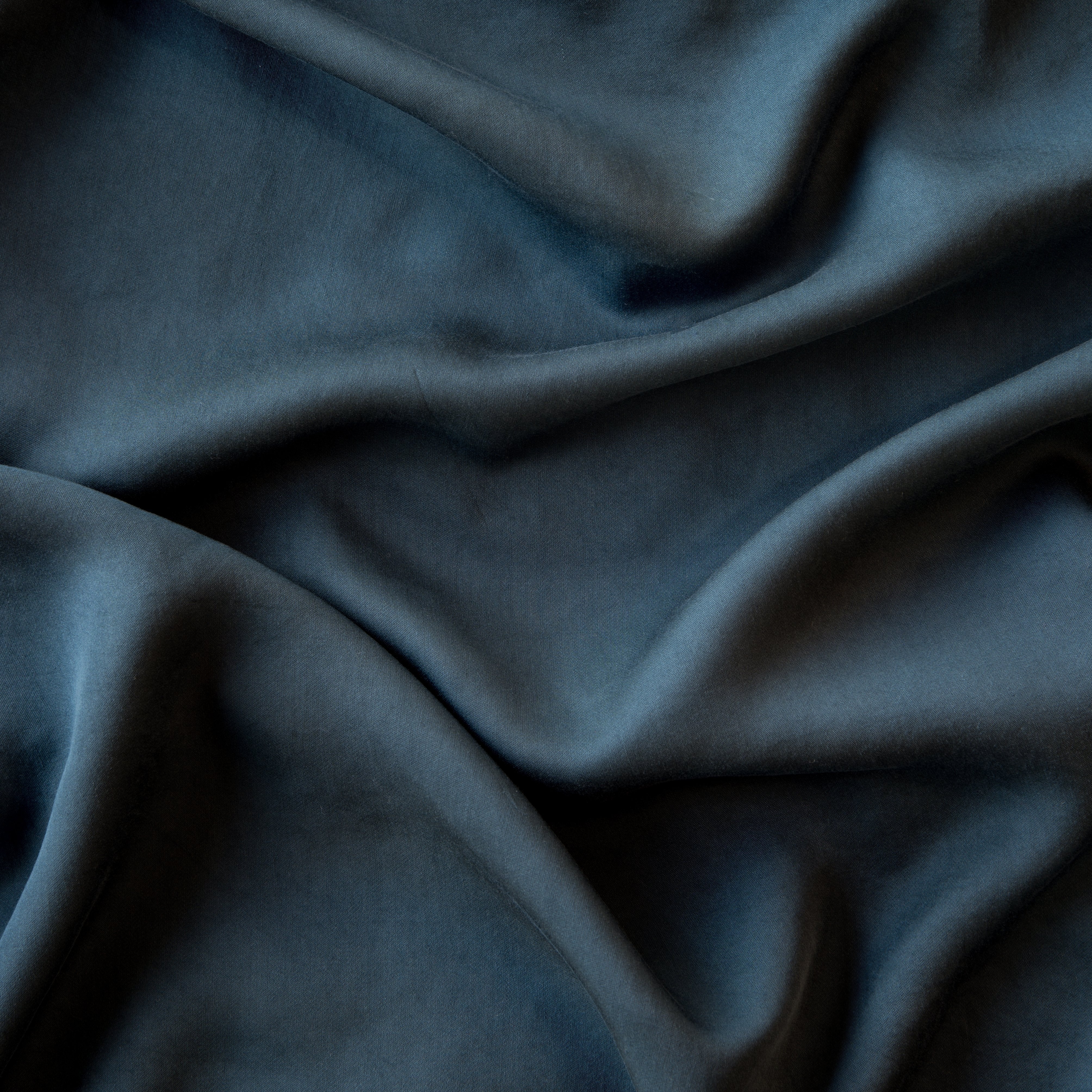 Midnight: A close up of Tencel™ fabric in midnight, a rich indigo tone. 