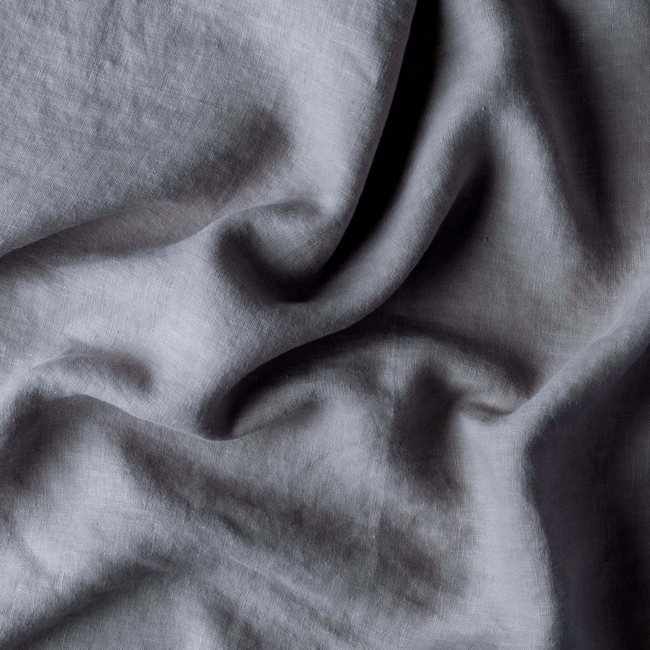 Moonlight: A close up of midweight linen in moonlight, a saturated, cool, mid-dark grey tone. 