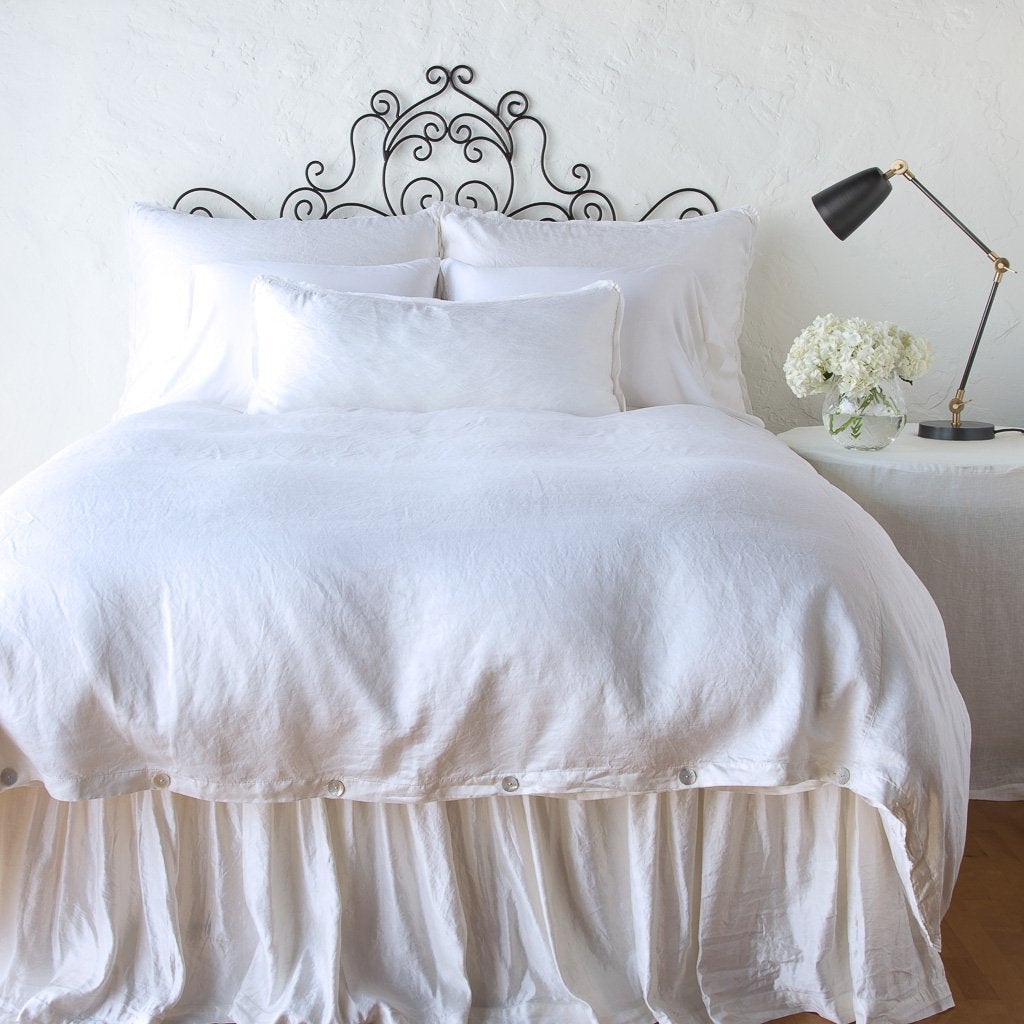 White: bed skirt with matching duvet and pillows - end of bed view.