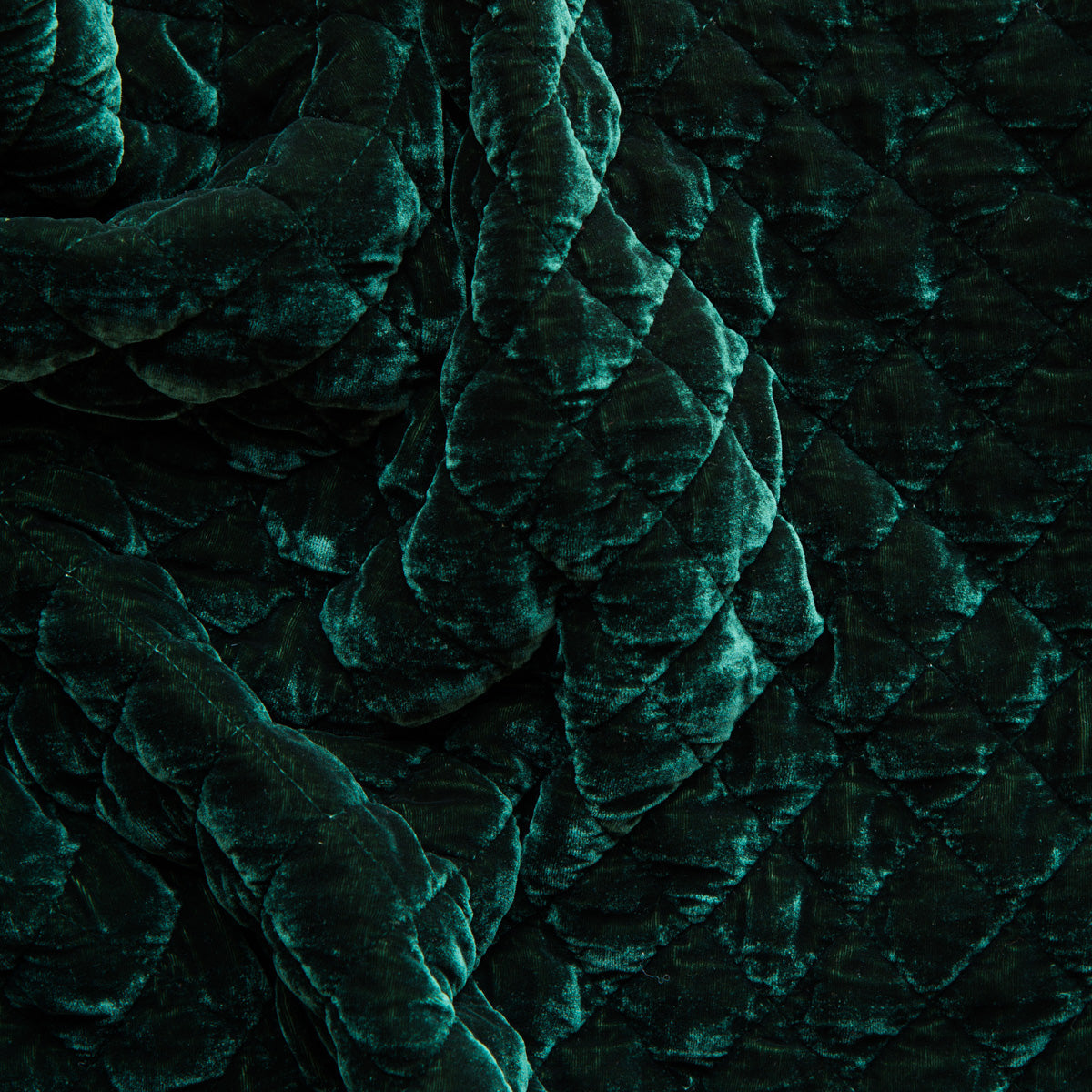 Jade: Close-up of quilted silk velvet in jade, a rich, verdant green with subtle blue undertones. 