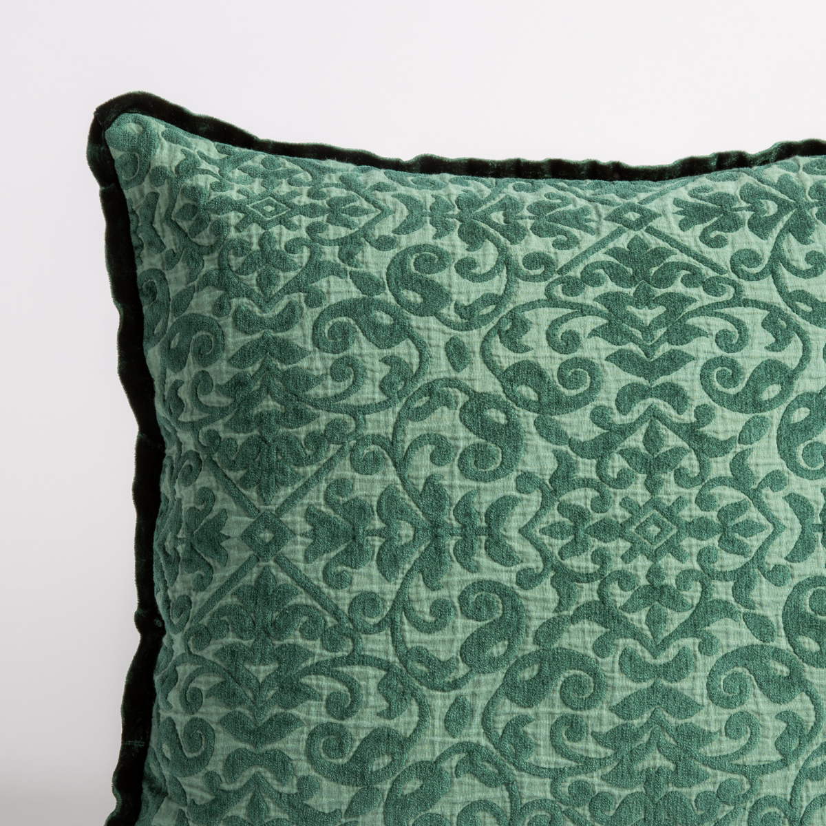 Jade: a close up of a vienna throw pillow corner, showing trim and pattern detail — straight on against a white background. 