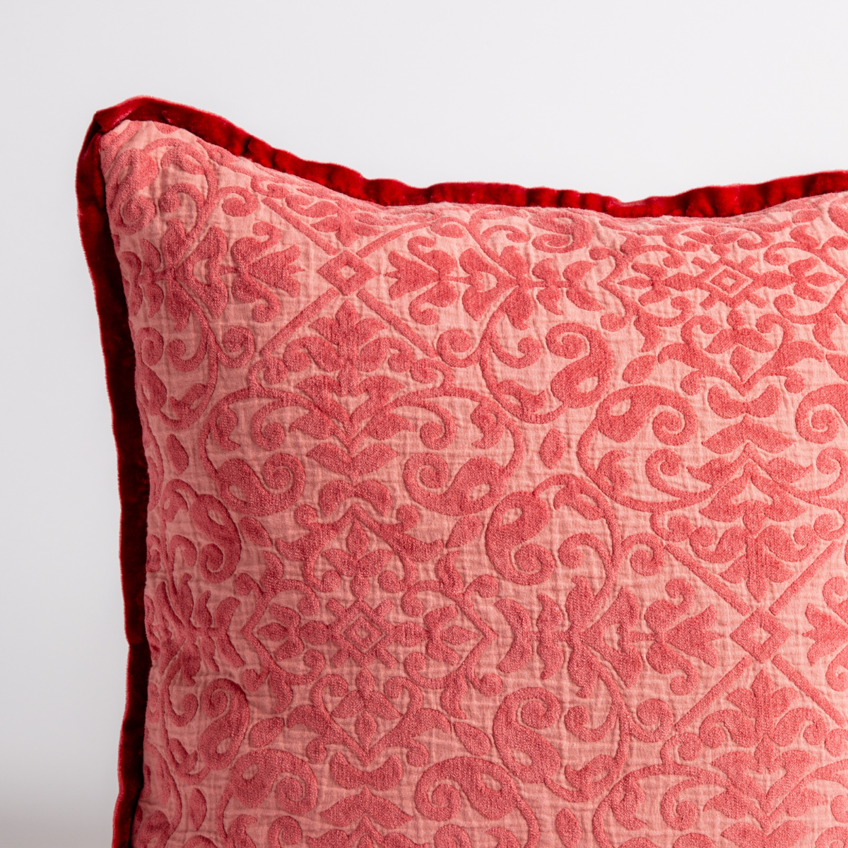 Poppy: a close up of a vienna throw pillow corner, showing trim and pattern detail — straight on against a white background. 