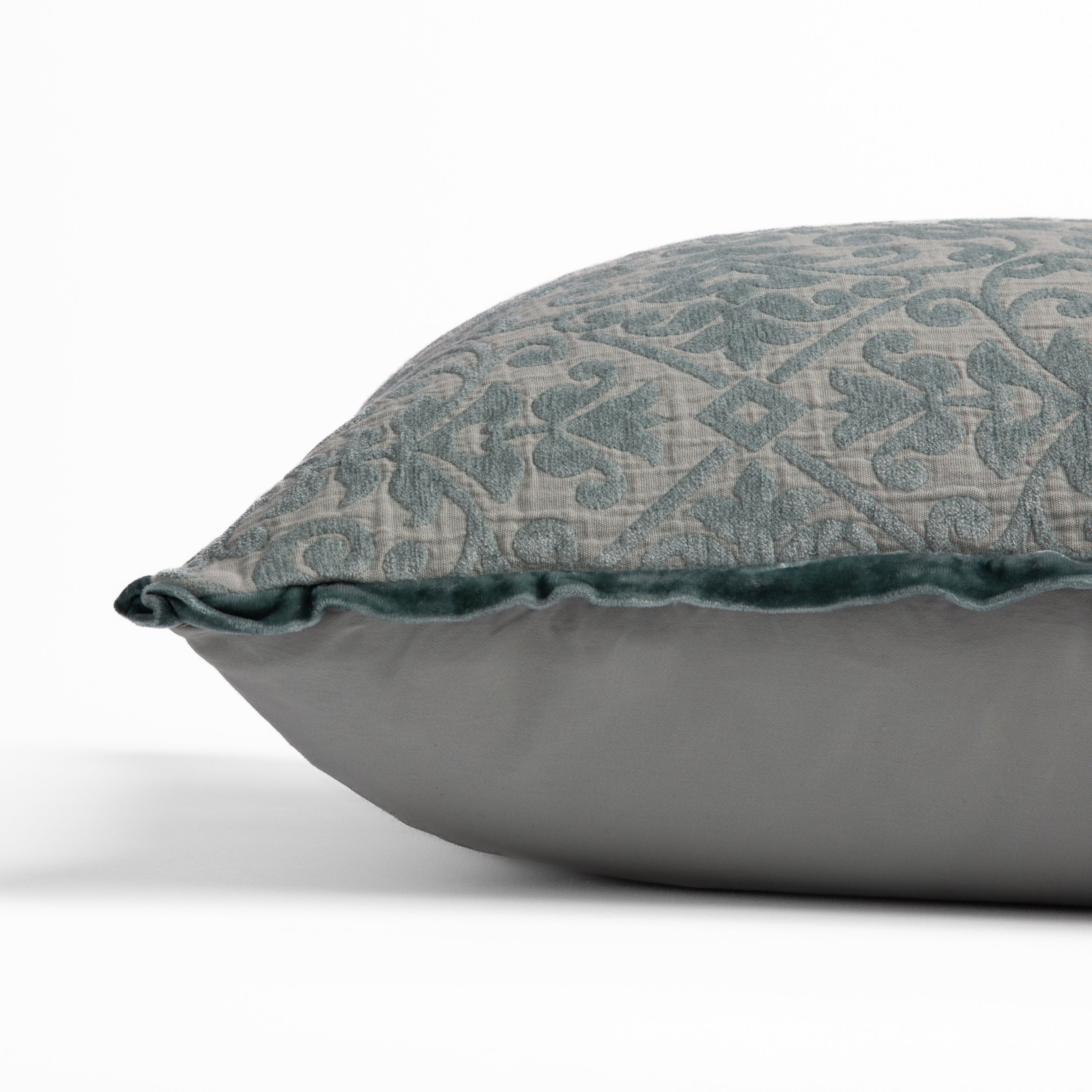 Eucalyptus: side view of 18x18 pillow shows cotton sateen back and silk velvet trim detail — close up against a white background. 