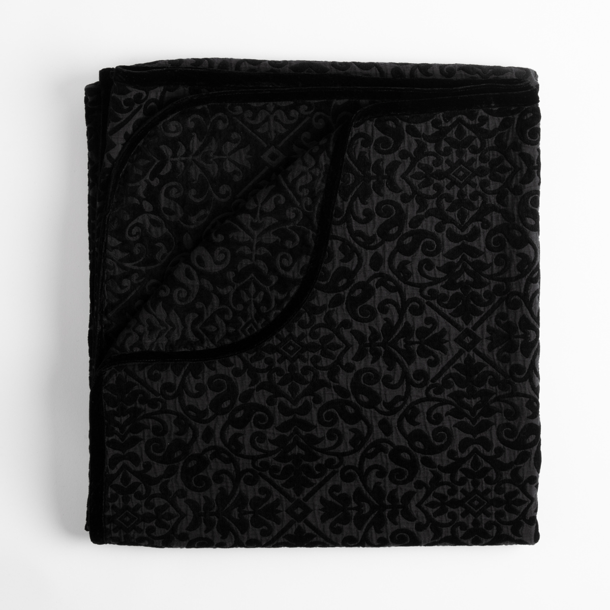 Corvino: folded blanket with corner folded down to show reverse side of blanket and silk velvet trim. 